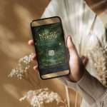 Hand holding phone showing enchanted forest digital RSVP with QR code