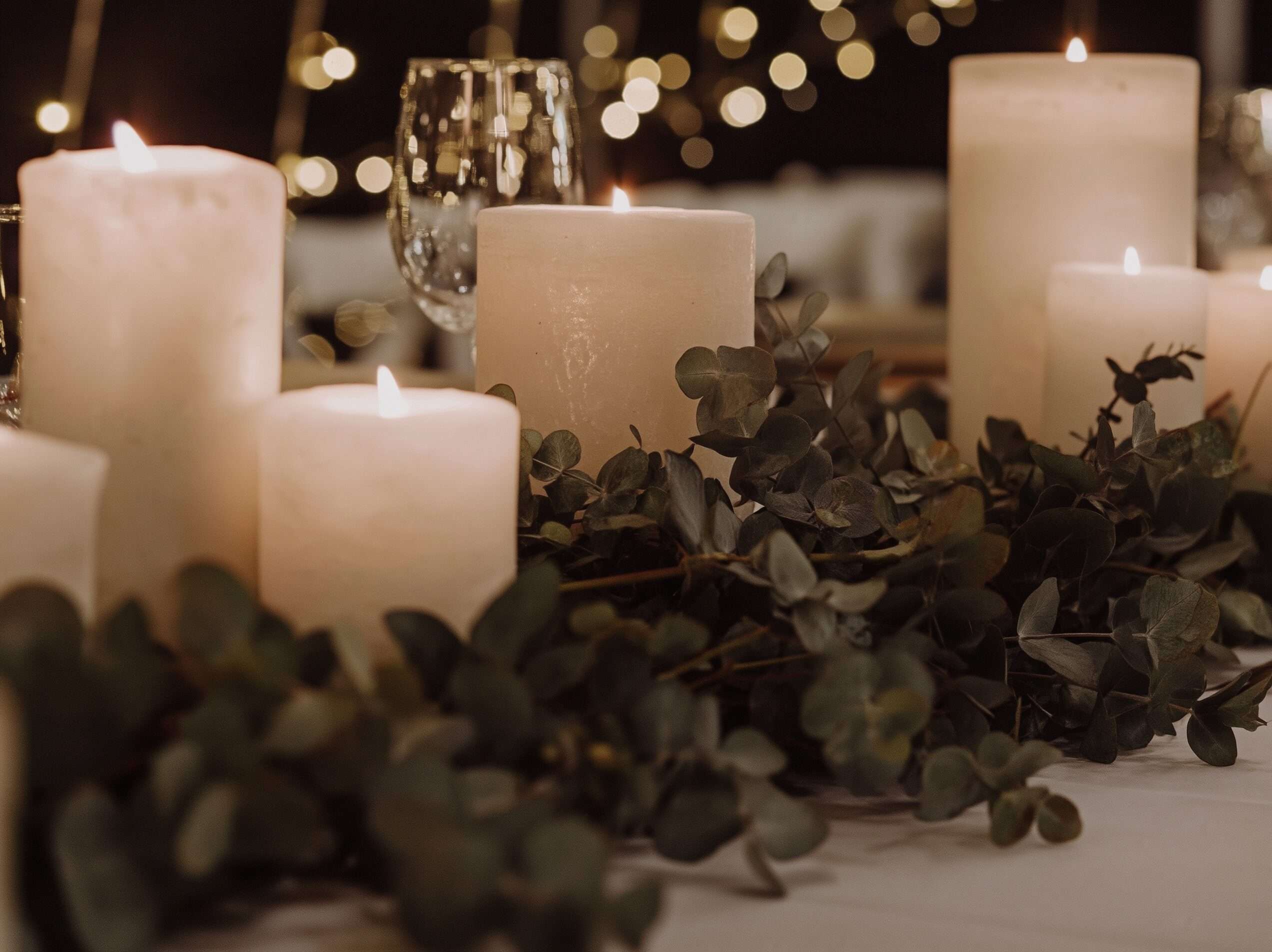Budget-friendly wedding dessert table with birch bark cake macarons berry tarts and fairy lights in a woodland setting