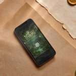 Enchanted forest digital RSVP on phone with parchment paper and gold wax seal