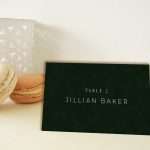 Enchanted Forest place card propped against macarons at a pale place setting