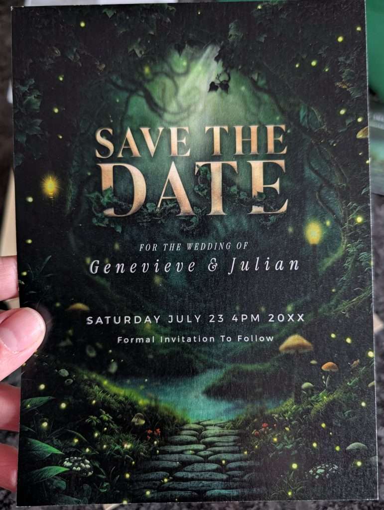 Enchanted Forest save the date card held in hand, close-up on the printed typography