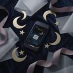 Midnight Celestial RSVP with QR reply code on a phone screen, among gold crescent moons and stars on grey silk