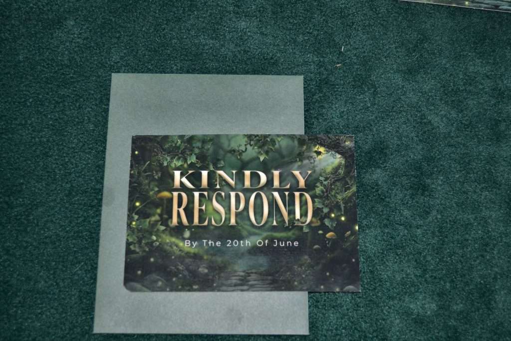 Printed Enchanted Forest RSVP card on dark green velvet