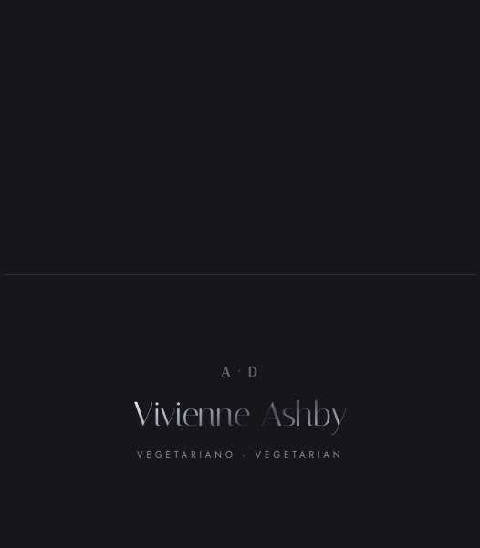 A tented place card, the guest's name and entree set in gunmetal over smoke black