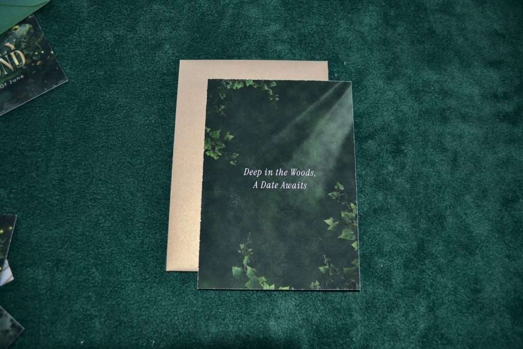 Back of an Enchanted Forest save the date card reading Deep in the Woods A Date Awaits