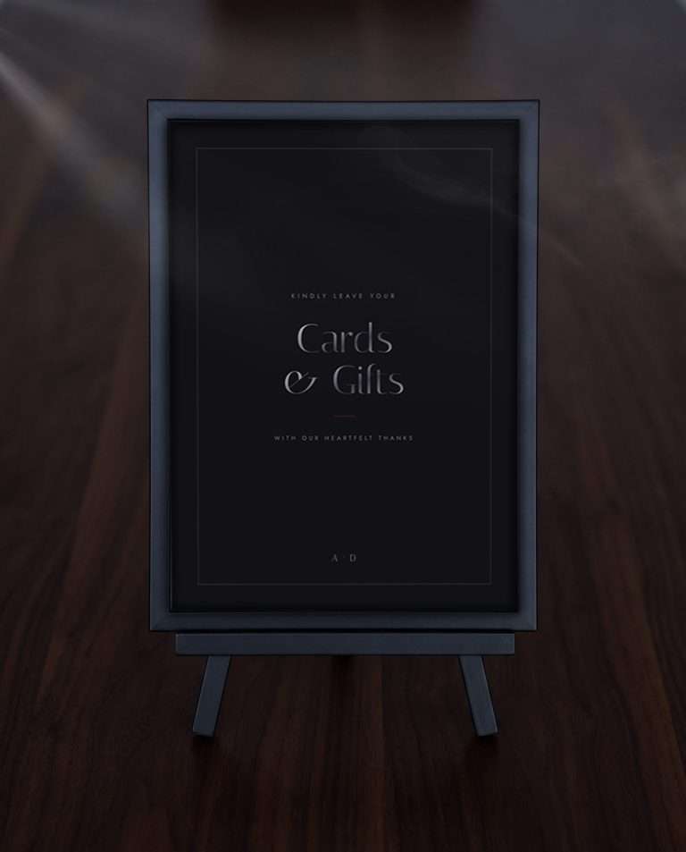 The Obsidian Vow cards and gifts sign framed on a black easel over dark wood