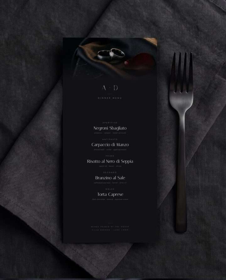 A dark dinner menu card set in gunmetal type against a smoke black ground