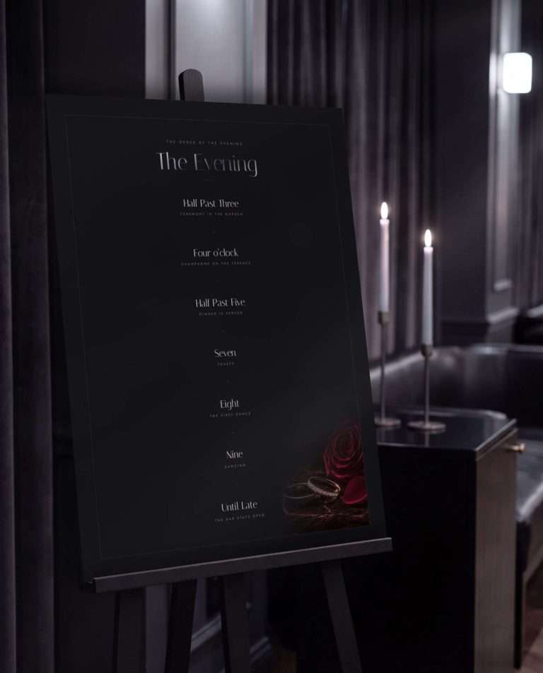 The 18 by 24 Obsidian Vow Order of the Evening sign on a black easel in a candlelit room, the timeline of the night set down its centre