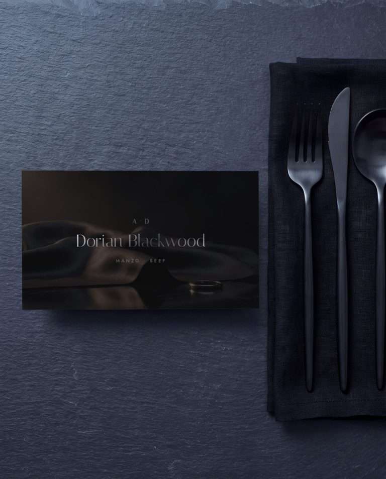 A flat place card, the guest's name and entree set in gunmetal over smoke black