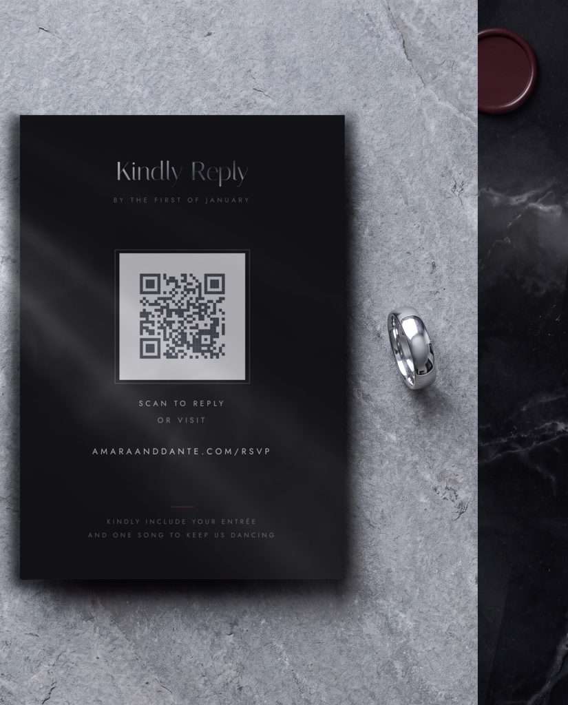 The Obsidian Vow reply card with its QR code, on pale marble beside a single silver band
