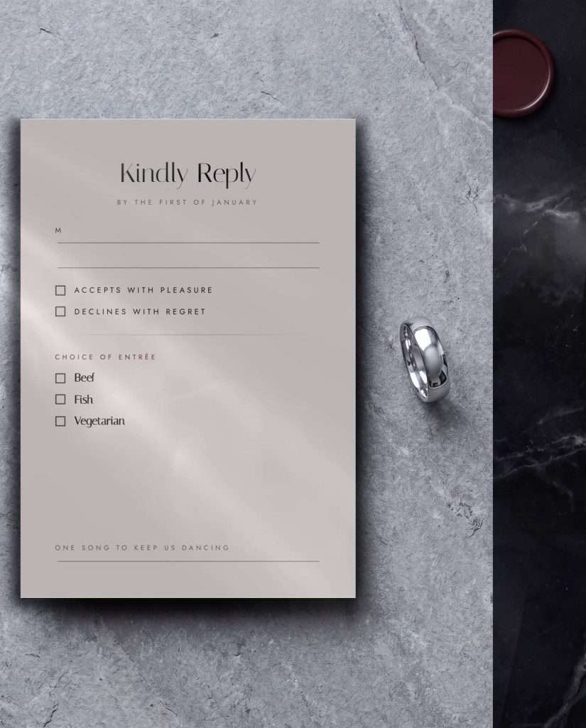 The Obsidian Vow write in reply card on stone stock, Kindly Reply with entree choices, on grey stone beside a silver ring and a deep wine wax seal