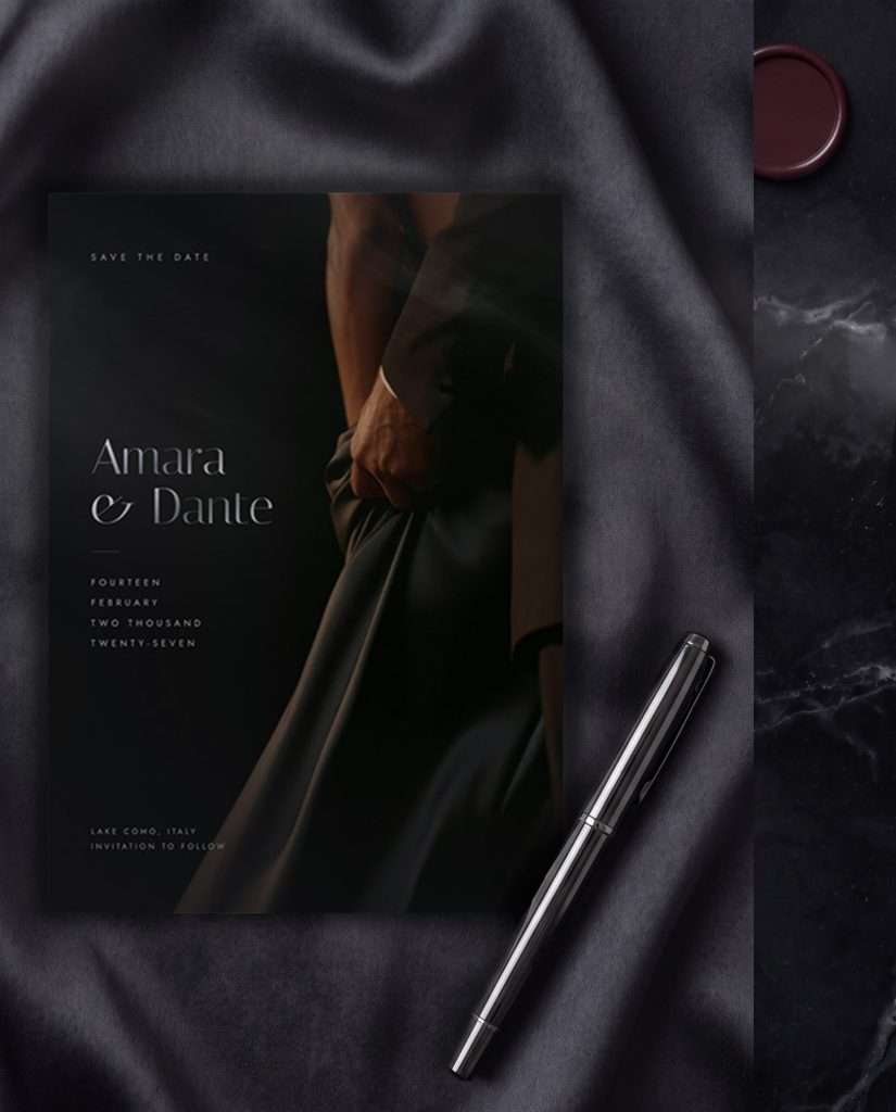 The Obsidian Vow save the date lying on dark silk, a silver pen and a deep wine wax seal beside it